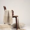 Manta y cojines de lino europeo en tonos grises sobre silla de Muebles de 114